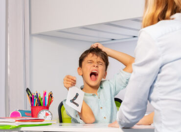 Child showing signs of ADHD, such as inattention and hyperactivity during learning activity