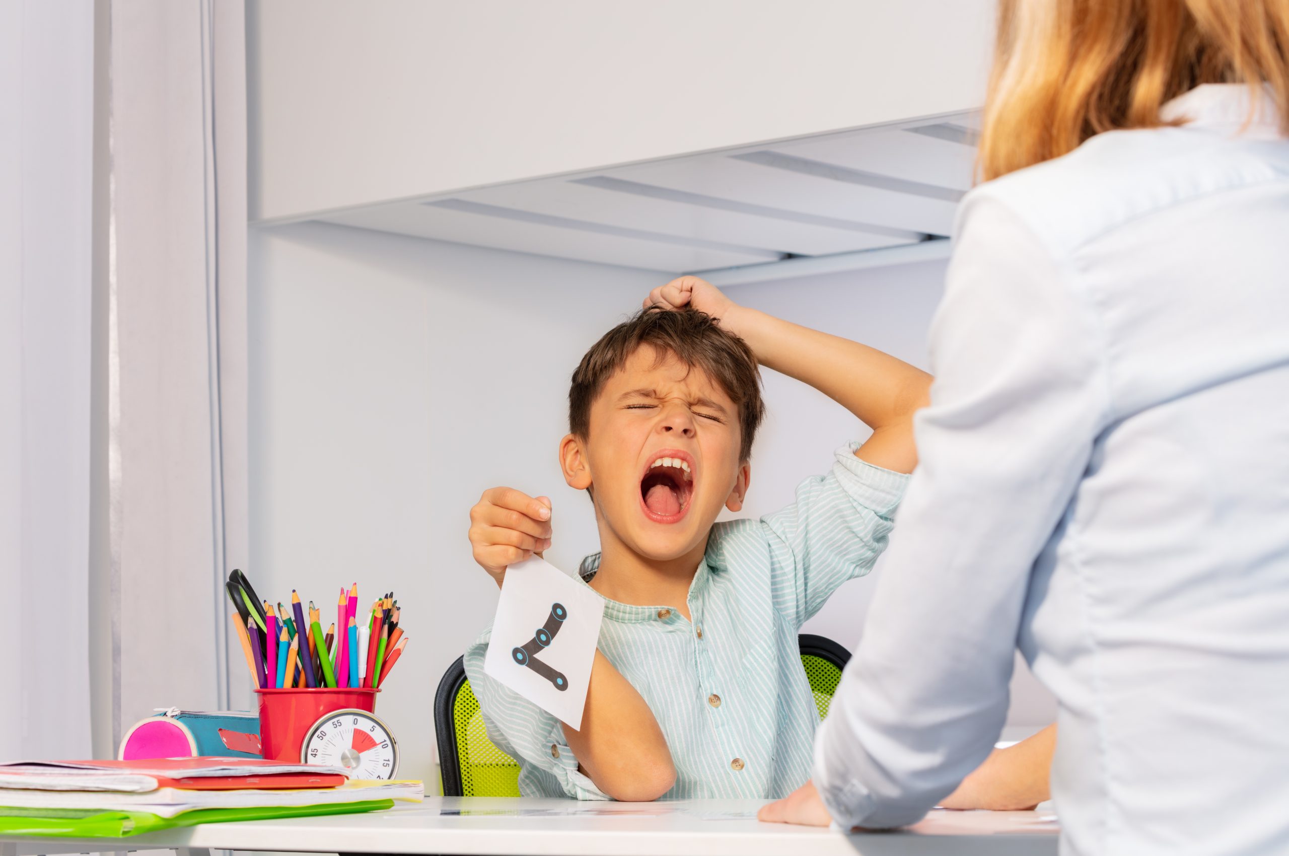 Child showing signs of ADHD, such as inattention and hyperactivity during learning activity