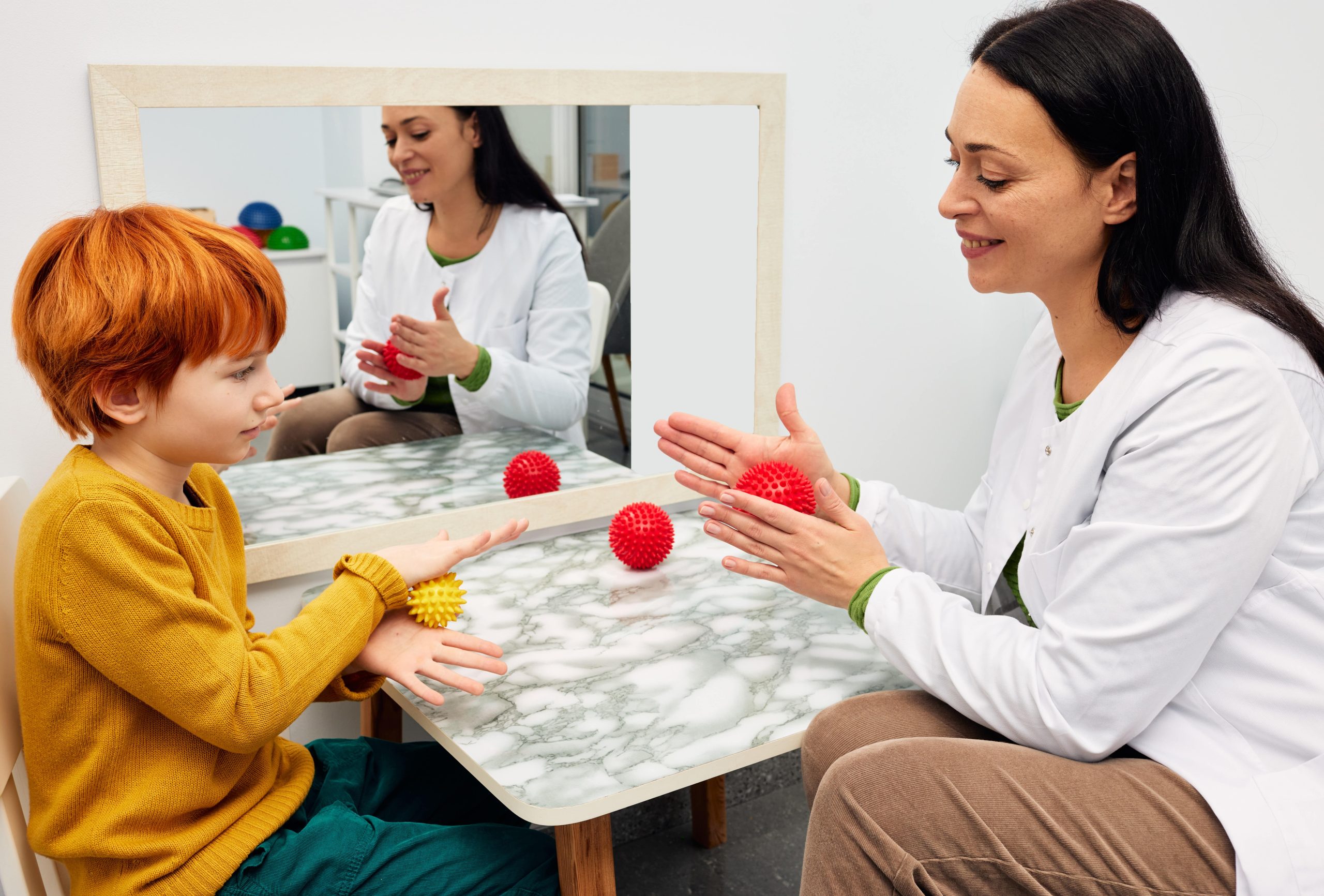 Child using sensory tools during occupational therapy session to manage anxiety and improve emotional regulation