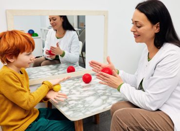 Child using sensory tools during occupational therapy session to manage anxiety and improve emotional regulation