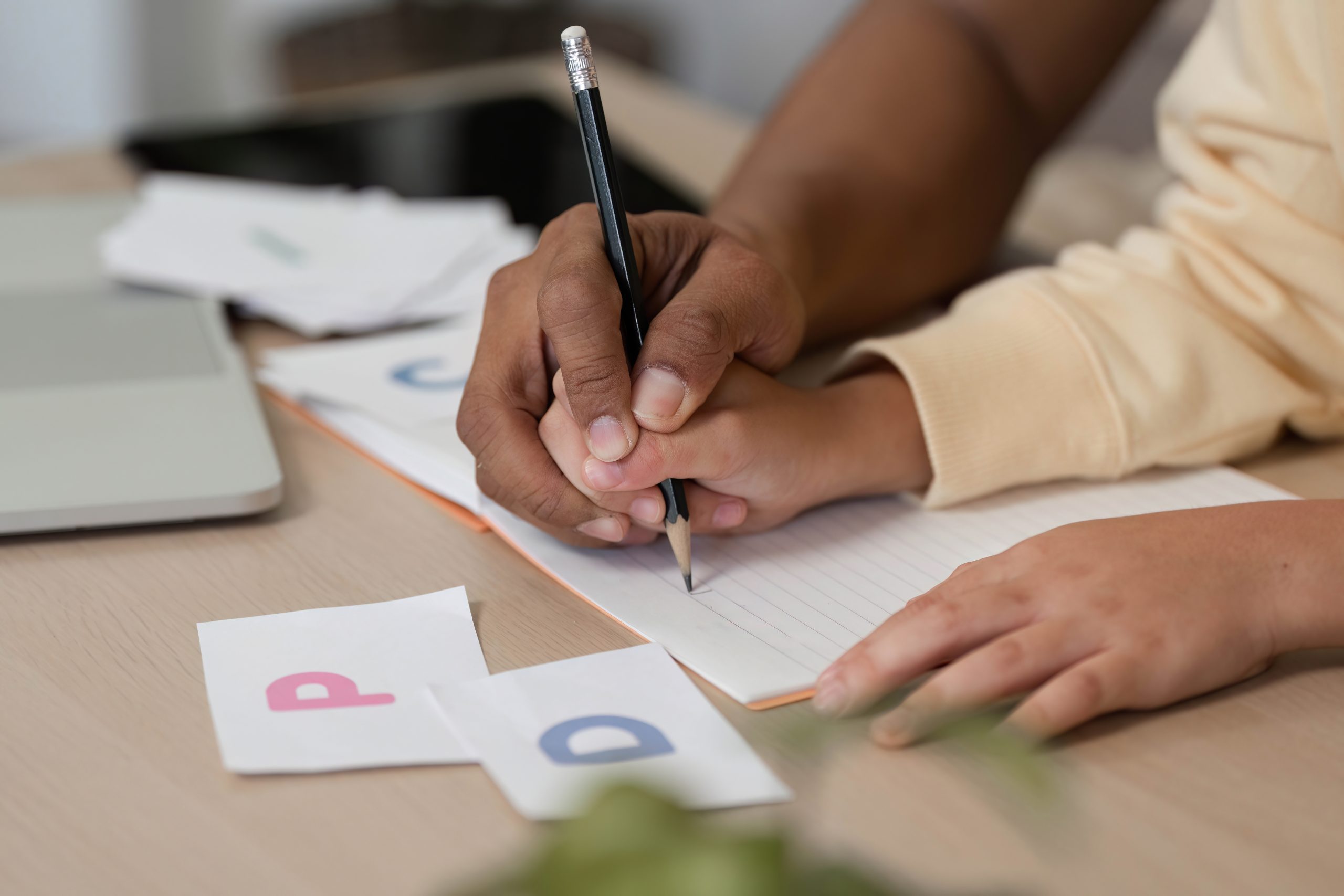 Child practicing handwriting therapy with guided occupational exercises to improve fine motor skills.